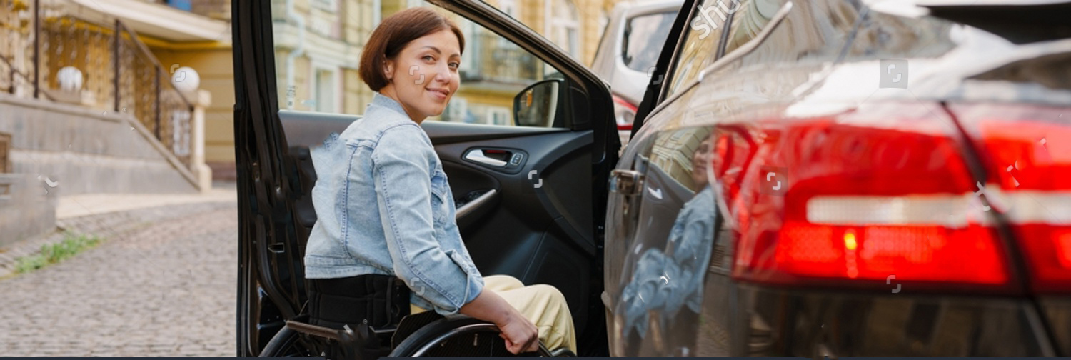 stock-photo-brunette-woman-smiling-and-sitting-in-wheelchair-by-car-on-city-street-2158081889